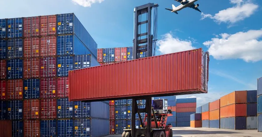 Container Handling for Strategic Import Setup – Xaviour Holding Importing into Spain – cargo container lifted at logistics hub | X.H Marketplace